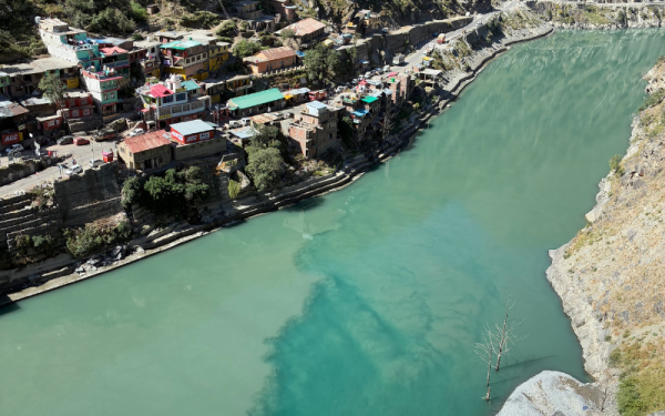 A town on the edge of a blue-green river