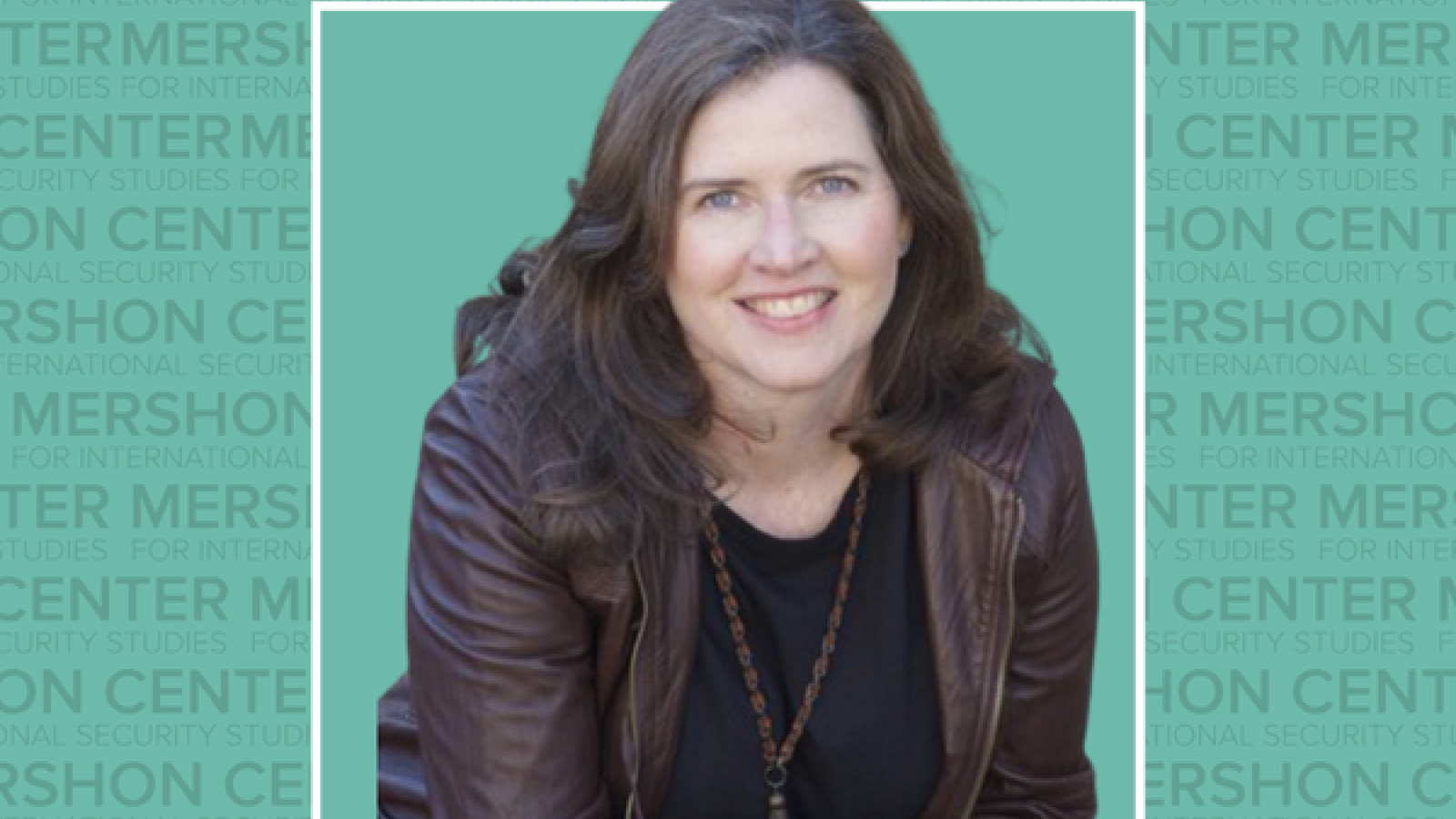 A picture of a woman with long brown hair, a brown leather jacket, smiling, set against a blue background with the Mershon Center logo overlay.