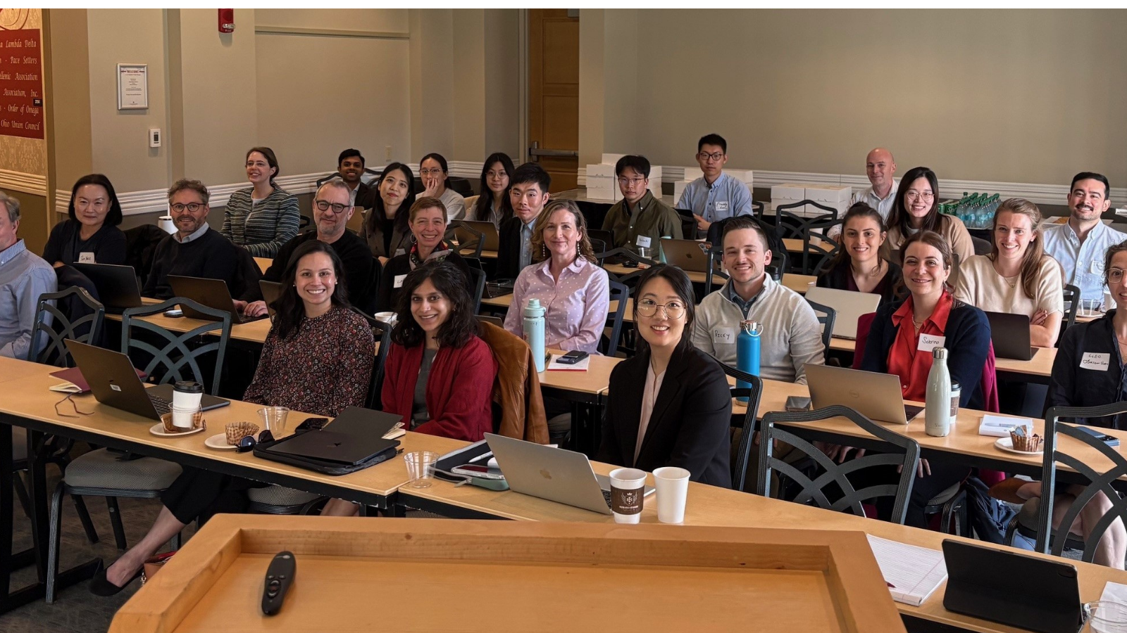 2 dozen people sitting at desks