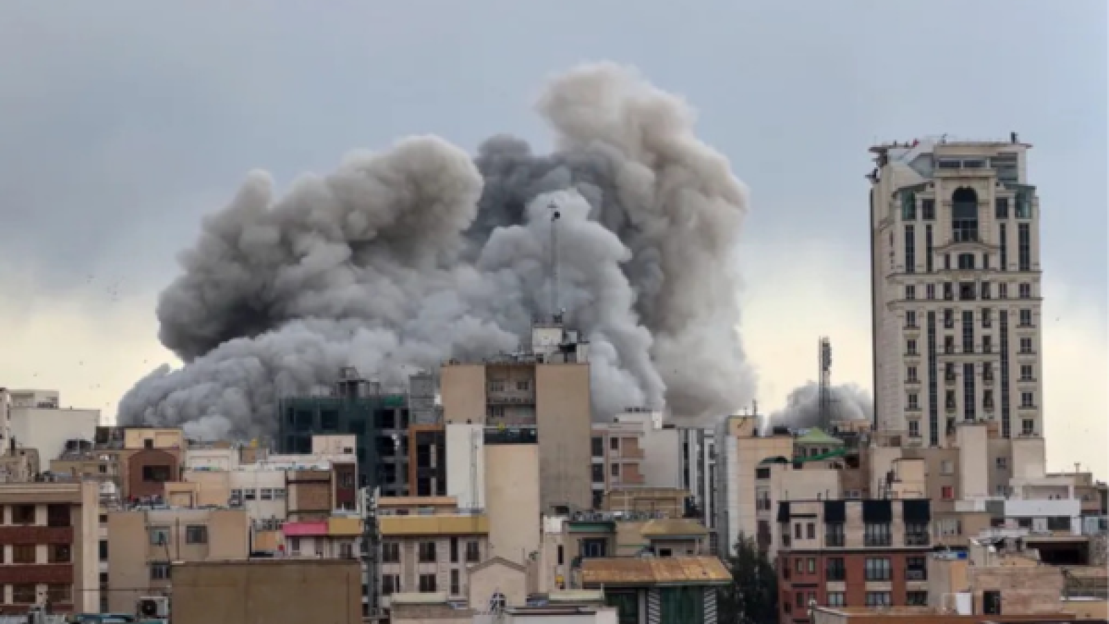 A plume of smoke rises over an attack on Tehran, Iran on March 2, 2026