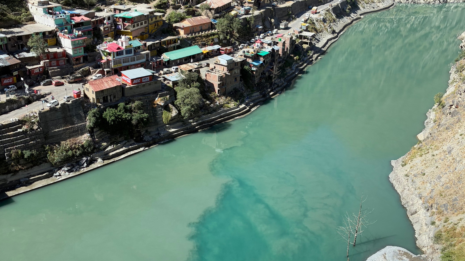 A town on the edge of a blue-green river